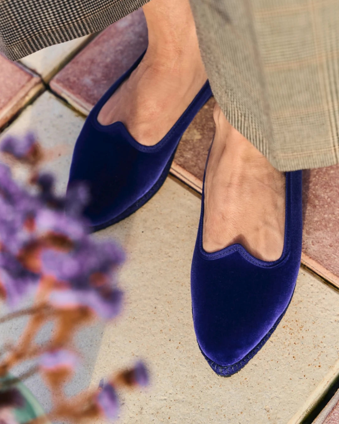 Blue velvet pointed toe friulane shoes worn with tailored trousers