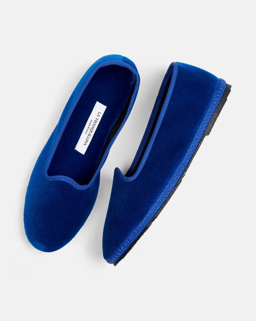 Pair of blue velvet Venetian friulane shoes by LA TRANQUILLINA, showing the classic slipper silhouette and hand-sewn sole.