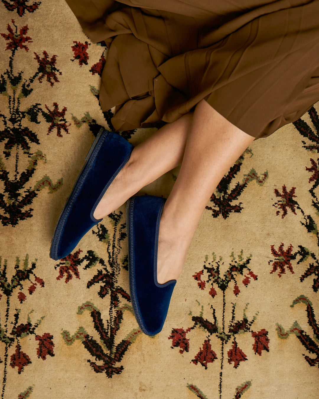 Blue velvet Rialto friulane shoes by LA TRANQUILLINA worn on patterned carpet