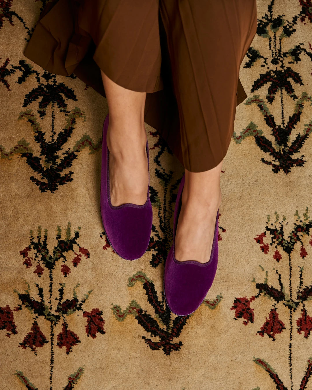 Purple velvet Rialto friulane shoes by LA TRANQUILLINA worn on patterned carpet